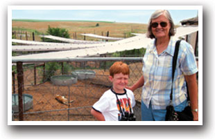 Lady and boy in front of animal habitats at Rocky Mountain Wildlife Sanctuary in Keenesburg, Colorado