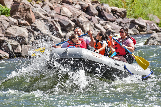 Family in whitewater raft paddling down the Upper Colorado River with Agate Dog-Geo Tours Whitewater Rafting Trip near Denver in Morrison, Colorado