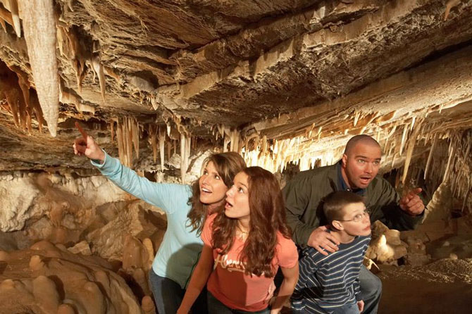 Family exploring Glenwood Caverns and Adventure Park inside a cave at Glenwood Springs Colorado