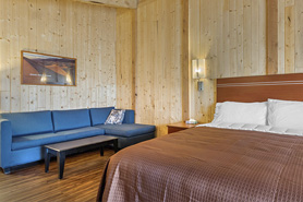 Inside view of deluxe-plus large room with king size bed and sofa at Great Sand Dunes Lodge in Alamosa, Colorado.