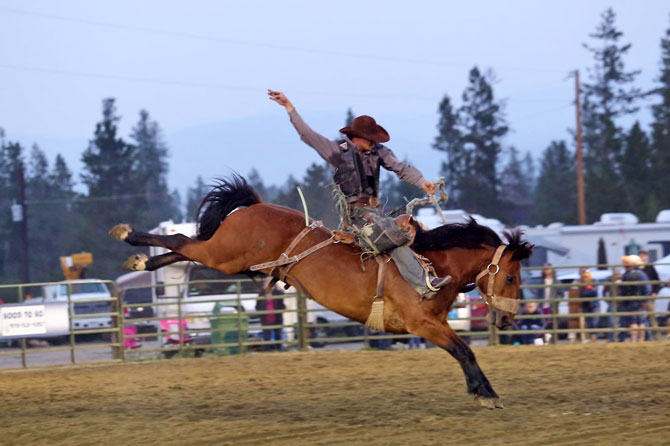 A bucking bronco rider at the High Country Stampede Rodeo in Winter Park, Colorado. Everyone has fun. The high country stampede rodeo Saturday nights. July through mid-August.