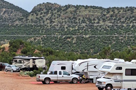 RVs and trailers parked in camping sites with full hookups at Indian Springs Ranch and Campground in the Royal Gorge area of Colorado.
