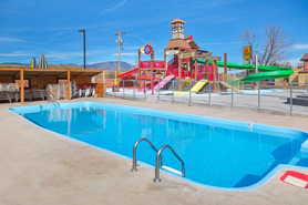 A pool at Colorado Springs KOA in Colorado Springs, Colorado. Enjoy ice cream socials, friday movies, the swimming pool, hot tub, and splash park!