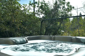 Outdoor hot tub under a blue sky at Green Mountain Falls Vacation Rentals in Green Mountain Falls, Colorado.