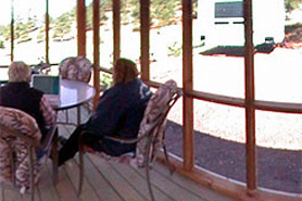 People sitting inside a screened in porch at Lost Burro Camping and Lodging in Cripple Creek, Colorado