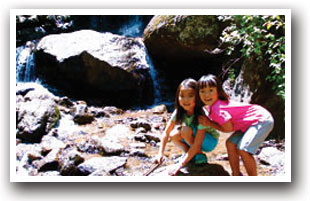 Two girls in front of Green Mountain Falls just outside of Colorado Springs, Colorado