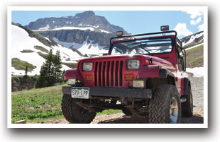 At the summit of a pass in a Jeep or ATV, Colorado Vacation Directory