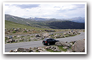 Car driving along the Pikes Peak Tollroad Scenic Drive , Colorado