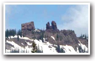 Snowmobiling near Rabbit Ears rock formation, Colorado