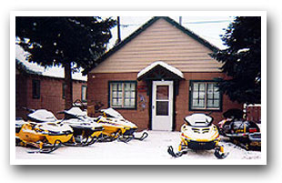 Snowmobiles in front of cabin at Grand Lake, Colorado Vacation Directory