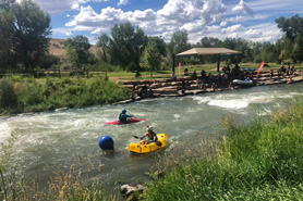 Kayakers training in the Uncompahgre River at Montrose Water Sports Park, Colorado.