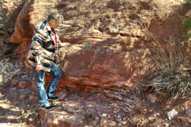 Tour guide pointing to fossils at Indian Springs Trace Fossil Site near Canon City, Colorado.