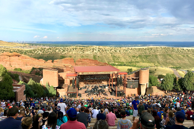 View of main stage with downtown Denver in the distance from the top of Red Rocks Park and Amphitheatre in Morrison, Colorado.