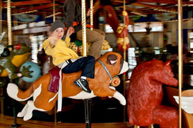 Child riding the Carousel of Happiness in Nederland, Colorado.