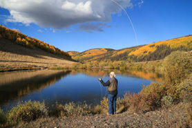 Person fly fishing the on-site pond at Oleo Ranch in Lake City, Colorado.