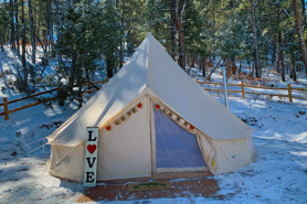 Entrance to cozy glamping tent in the winter with welcoming love sign at Peaceful Peaks Ranch in Boncarbo, Colorado near Trinidad.