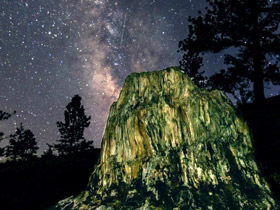 Large petrified stump formation at the Florissant Fossil Beds National Monument at night with a star-lit backdrop in the Pikes Peak area of Colorado.