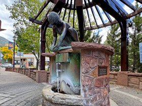 Spring Maiden sculpture atop the Stratton Springs Fountain mineral spring in downtown Manitou Springs, Colorado.