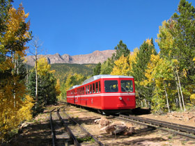 Train on the Pikes Peak Cog Railway during the fall in Manitou Springs, Colorado.