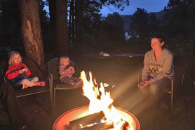 Family sitting around campfire at Pine River Lodge near Durango, Colorado