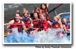 Close up of raters whitewater rafting in the Cache la Poudre, photo by Rocky Mountain Adventure