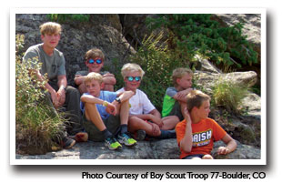 Young men resting on rocks after a long hike, Photo Courtesy of Boy Scout Troop 77-Boulder, CO