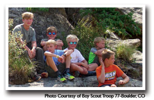 Young men resting on rocks after a long hike, Photo Courtesy of Boy Scout Troop 77-Boulder, CO