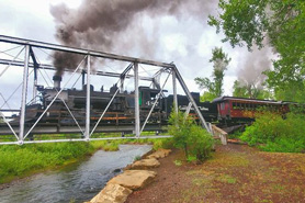 Cumbres and Toltec narrow gauge train crossing suspension bridge near Rio Chama RV Park located in Chama, New Mexico.