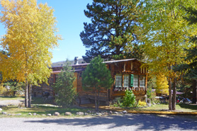 Aspen trees in the fall surrounding cabin at Riverbend Resort Cabins and RV Park, South Fork, Colorado. River-Front Cabins. Fishing. Scenic Drives. Hunting. Fantastic Fall Colors.