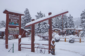 Snow falls on Riverbend Resort Cabins in the South Fork Area, Colorado. A Cozy Winter Destination. Trails For Snowmobiling and Snowshoeing.