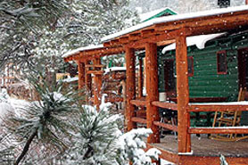 Snow falls on Riverbend Resort Cabins in the South Fork Area, Colorado