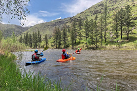 Kayakers taking an instructional class on the Cache La Poudre River with Rocky Mountain Adventures in Fort Collins, Colorado