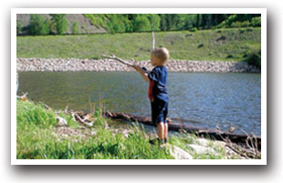Little boy fishing in Ruedi Reservoir, near Meredith and Basalt Colorado