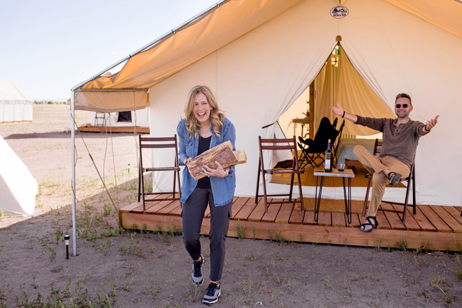 Campers having fun carrying fire wood and relaxing at Rustic Rook Resort located near the Great Sand Dunes in Alamosa, Colorado.