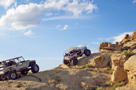 Jeeps 4 wheeling up a steep off-road rock trail in the Wagon Wheel West area at Rangelys Rock Crawling Park in Colorado