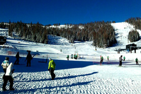 Skiers at the base of a lift at Wolf Creek Ski Resort near South Fork Lodge, Cabins & RV Park in South Fork, Colorado