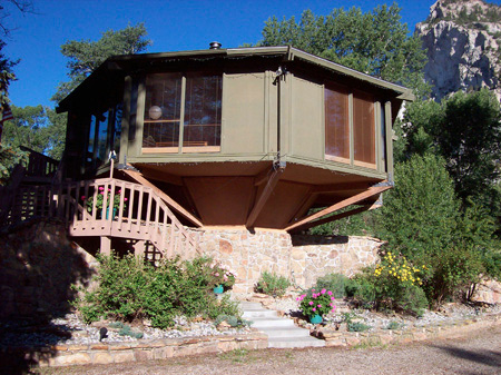 Sun shining on treehouse hot springs vacation home located in Buena Vista, Colorado