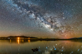 Dark sky photo of the Milky Way over Deweese Reservoir in Westcliffe, Colorado.