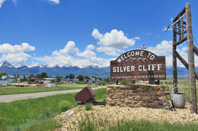 Welcome to Silver Cliff, A Colorado Mining Legend sign along the road entrance to the town.